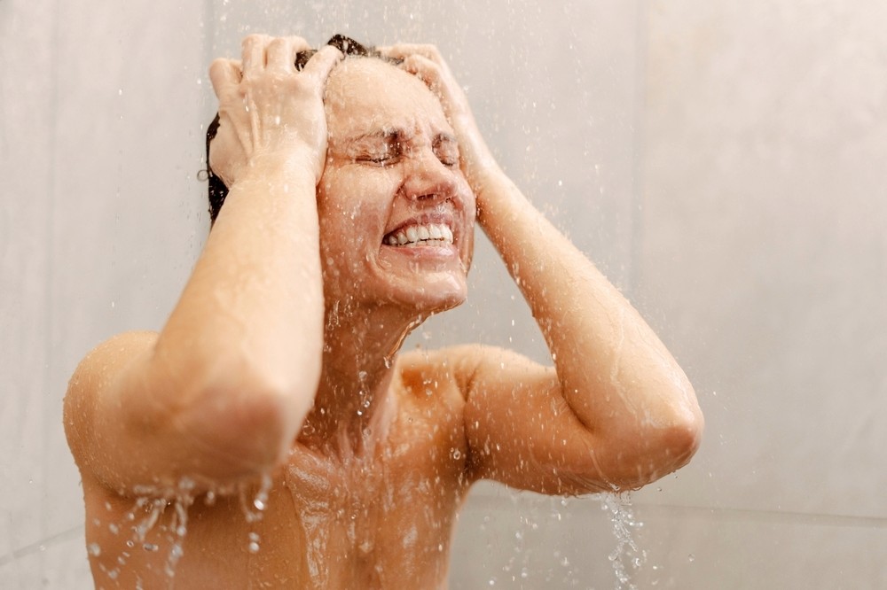 homeowner shivering under a cold shower spray