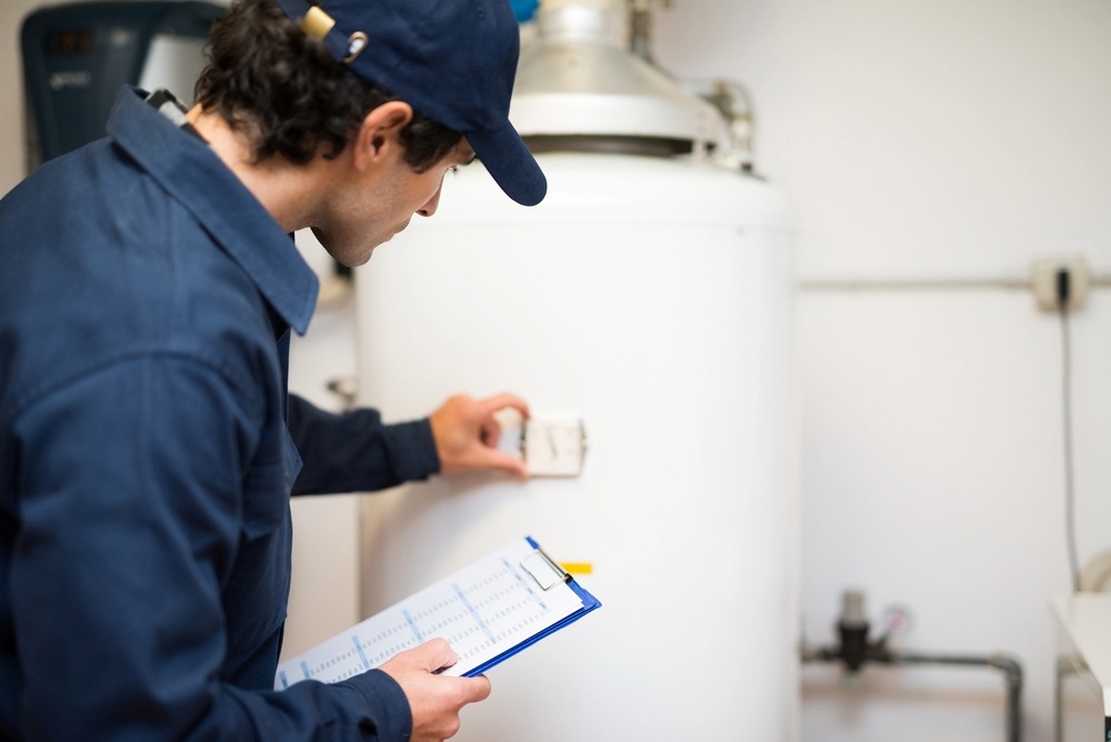 plumber inspecting a water heater